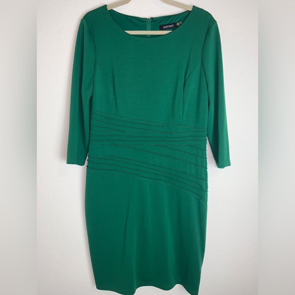 Ellen Tracey:  Dress adorned with intricate details around the waist